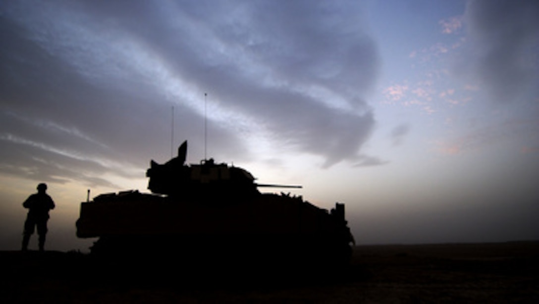 U.S. Army Spc. Jake Garrison keeps a look out by his M3A3 Bradley Cavalry Fighting Vehicle during a combat security patrol outside Ancient Samarra, near Ad Dwr, Iraq, on Nov. 17, 2004. Garrison is assigned to 1st Battalion, 4th Cavalry Regiment, 1st Infantry Division. 