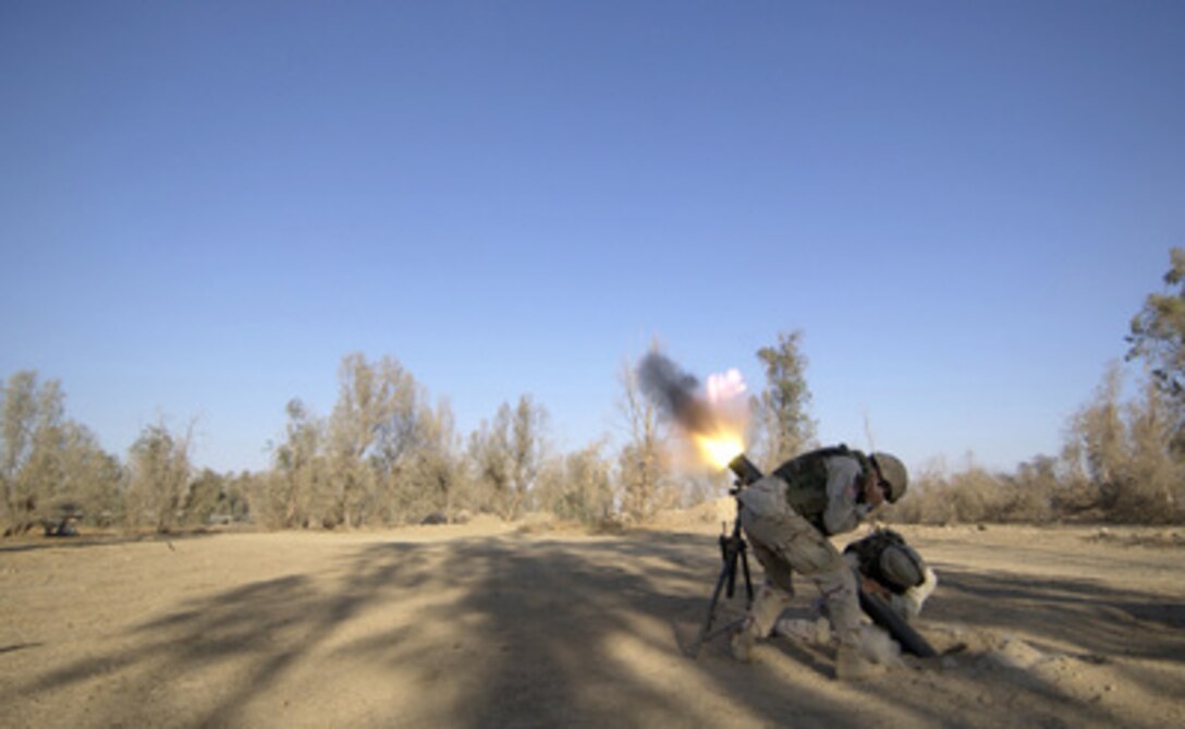 U.S. Army soldiers fire a 120-millimeter mortar round from Forward Operating Base Wilson in Iraq on Nov. 21, 2004. The mortar team is responsible for counter fire and terrain denial when anti-coalition forces fire on the base. The soldiers are assigned to 1st Battalion, 4th Cavalry Regiment, 1st Infantry Division. 