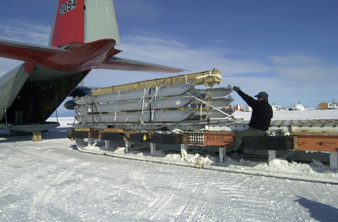 MCMURDO STATION, Antarctica -- Master Sgt. Carmello Modesto loads equipment sleds destined for the U.S. Antarctic Program's South Pole research station into the back of an LC-130 Hercules here.  The cargo plane, from the New York Air National Guard's 109th Airlift Wing, took the long way to the pole to retrace the route of the first South Pole flight by Rear Adm. Richard E. Byrd 75 years ago.  (Courtesy photo)