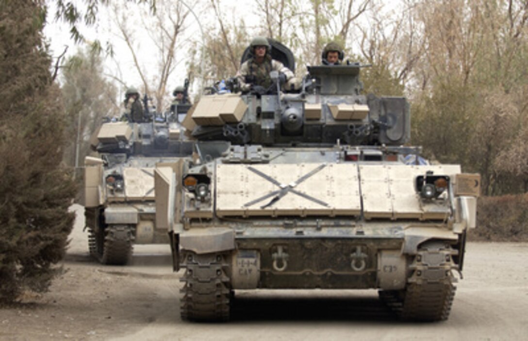 U.S. Army M3A3 Bradley Fighting Vehicles line up before heading out on a mission from Forward Operating Base Wilson in Iraq on Nov. 16, 2004. The Bradleys and their crews are assigned to Charlie Troop, 1st Battalion, 4th Cavalry Regiment, 1st Infantry Division. 