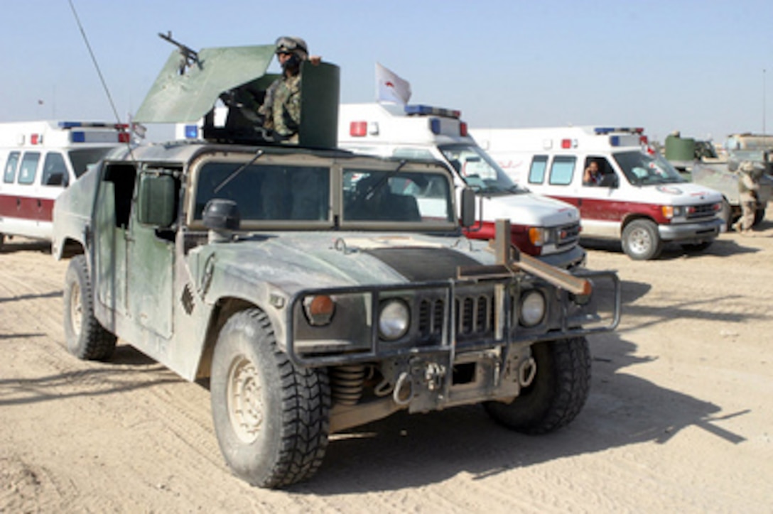 U.S. Marines provide security for the Iraqi Red Crescent Society during a convoy into Fallujah, Iraq, on Nov. 22, 2004. The Iraqi Red Crescent Society is providing humanitarian relief and medical aid for citizens inside the city. The Marines are assigned to 2nd Battalion, 11th Marine Regiment, 1st Marine Division. 