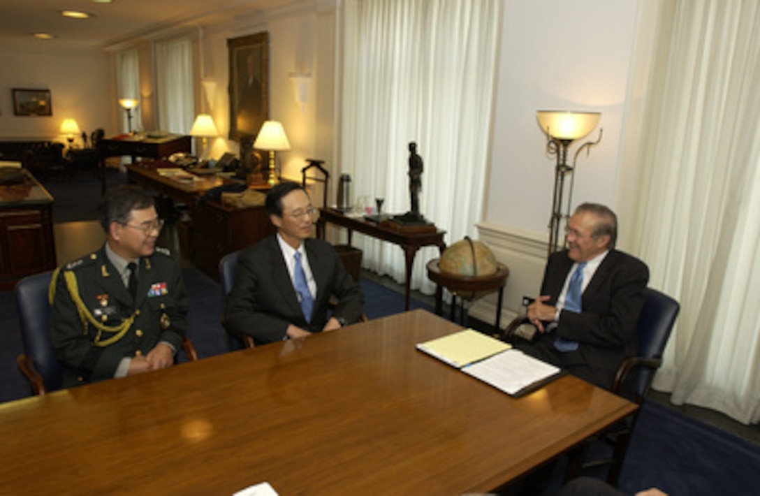 Secretary of Defense Donald H. Rumsfeld (right) meets in his Pentagon office with South Korean Ambassador to the United States Han Sung Joo (center) and Maj. Gen. Moon Young Han (left) on Oct. 1, 2004. The two leaders and their senior advisors met to discuss defense issues of mutual interest. 