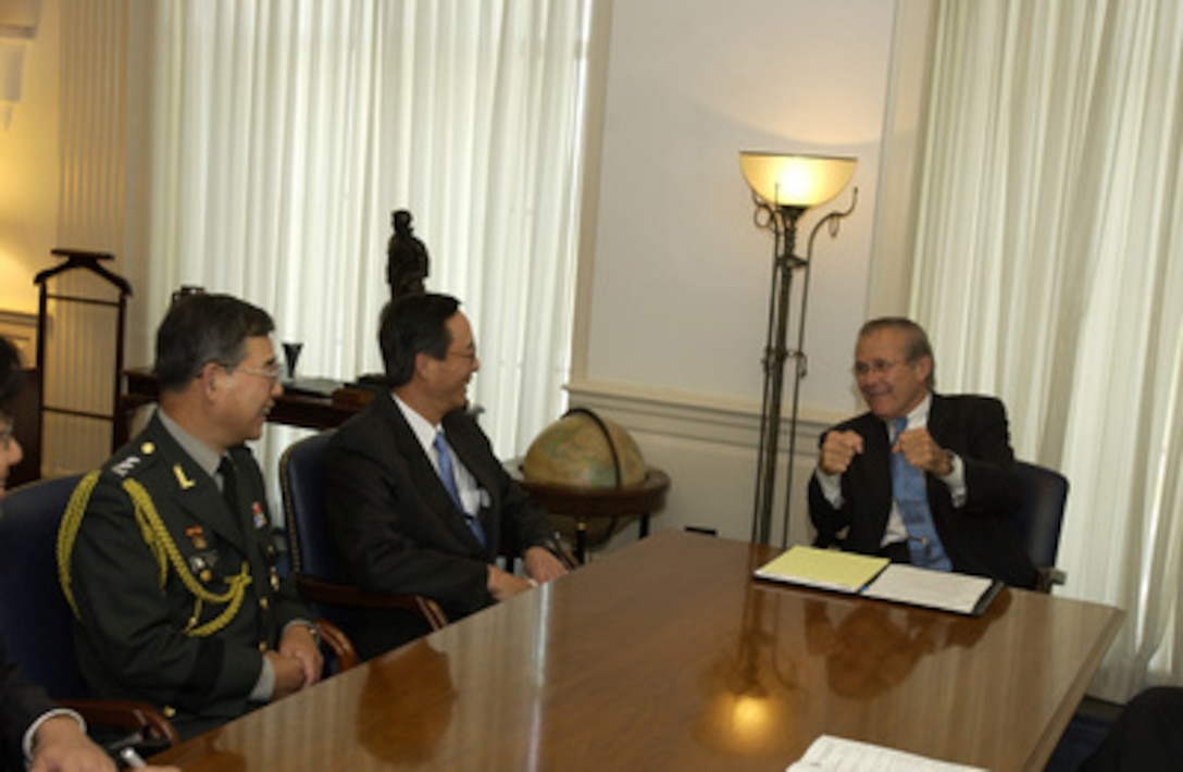 Secretary of Defense Donald H. Rumsfeld (right) meets in his Pentagon office with South Korean Ambassador to the United States Han Sung Joo (center) and Maj. Gen. Moon Young Han (left) on Oct. 1, 2004. The two leaders and their senior advisors met to discuss defense issues of mutual interest. 