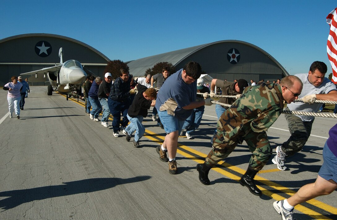 DAYTON, Ohio -- A men's team participates in the 6th annual Combined Federal Campaign Aircraft Pull event at the Air Force Museum here Oct. 5.  Male, female and coed teams competed to see who could pull a 60,000-pound EF-111 Raven the farthest in 45 seconds.  The farthest pull was 338 feet, 11 inches by a men's team.  In all, 26 teams competed and raised $5,400 for CFC charities.  (U.S. Air Force photo by Rob Brenner)