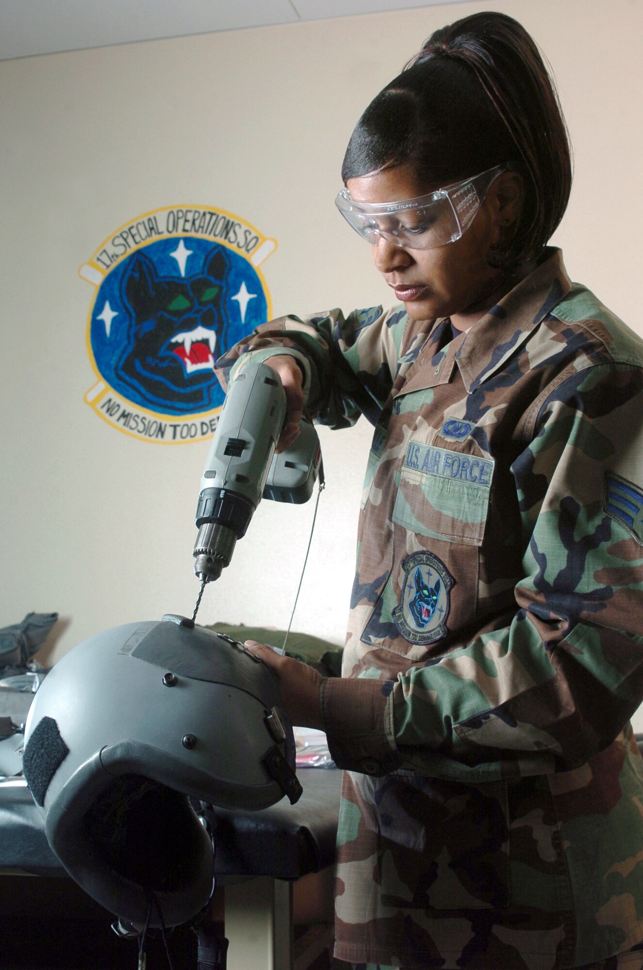 KADENA AIR BASE, Japan -- Senior Airman Patrina Fonville drills holes in a helmet to install bayonet receivers and a night-vision goggle mount.  She is a life-support technician with the 17th Special Operations Squadron here.  (U.S. Air Force photo by Master Sgt. Val Gempis)
