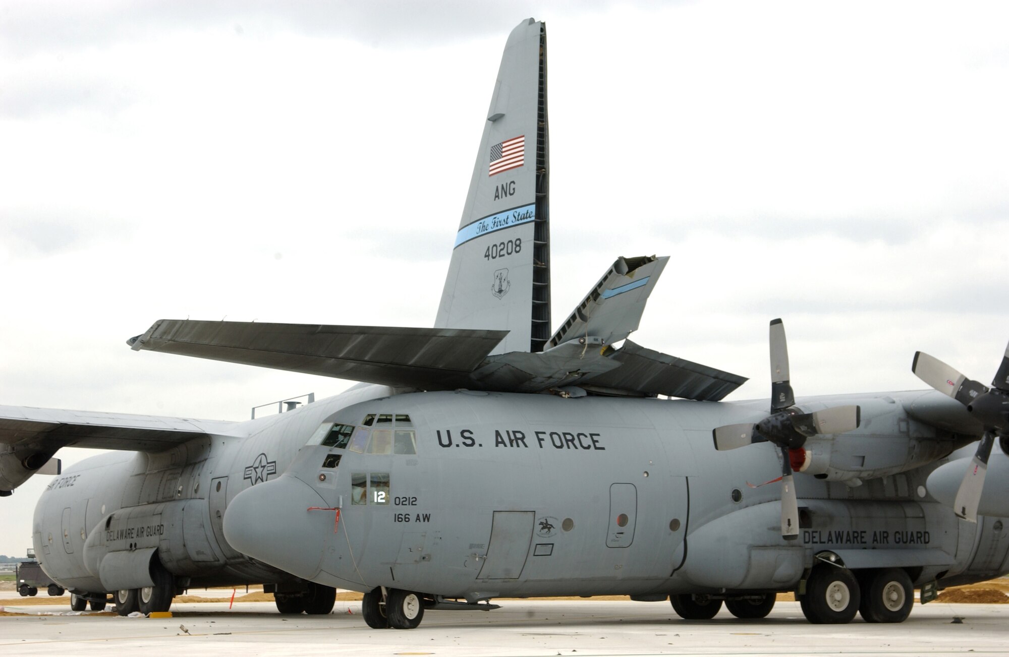 NEW CASTLE, Del. - A C-130 Hercules was pushed underneath another aircraft due to a tornado that touched down here Sept. 28.  The aircraft are assigned to the Delaware Air National Guard's 166th Airlift Wing.  (U.S. Air Force photo by Senior Airman Melissa E.Chatham)