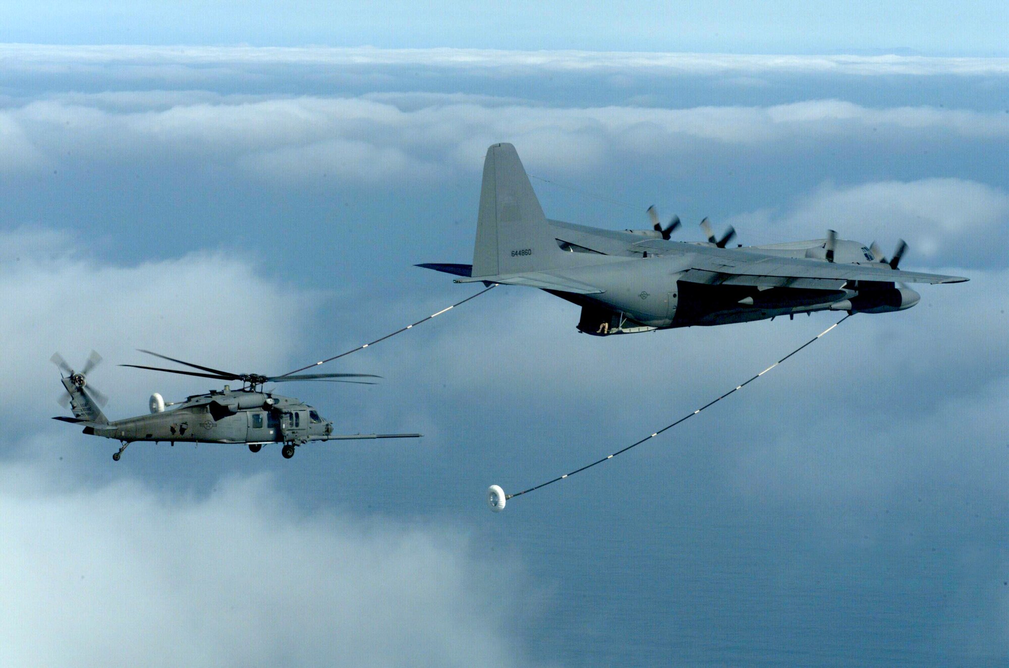 OVER SAN DIEGO, Calif. - An HH-60 from the 55th Rescue Squadron's moves in to refuel from the 79th Rescue Squadron's C-130 here.  This is part of a water rescue training exercise conducted jointly between the 55th, 79th, and 48th Rescue Squadrons, all a part of the Air Force Search and Rescue Operations Mission at Davis-Monthan Air Force Base, Ariz. (U.S. Air Force photo by Staff Sgt. Lanie McNeal) 