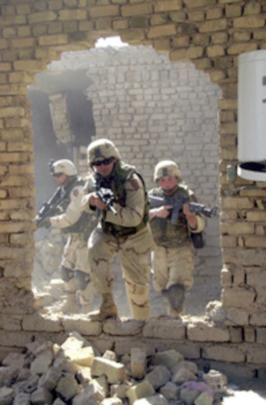 U.S. Army soldiers conduct house-to-house searches during Operation Baton Rouge, a joint combat operation in Samarra, Iraq, on Oct. 1, 2004. The soldiers are with the 1st Battalion, 77th Armor Regiment, 1st Infantry Division. 