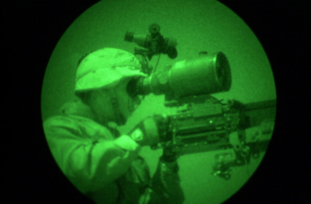 A U.S. Army soldier uses a high-powered scope to keep a watchful eye on activity during combat operations in Samarra, Iraq, on Oct. 1, 2004. The photo was taken using night vision technology. 