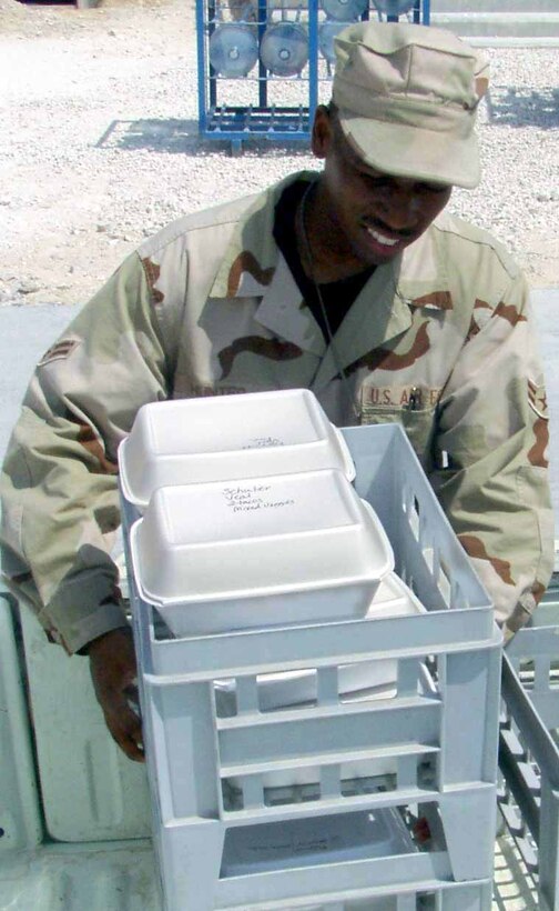 SOUTHWEST ASIA -- Airman 1st Class Brian Hunter helps load boxed meals into a truck for security forces Airmen at a forward-deployed location.  Airman Hunter plays one of many vital roles in bringing food to Airmen throughout the base.  He is from Luke Air Force Base, Ariz.  (U.S. Air Force photo by Staff Sgt. Bryan Bouchard)