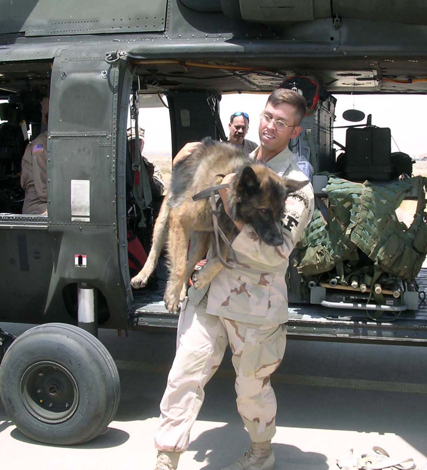 SOUTHWEST ASIA -- Staff Sgt. Jonathan Eha carries Mathys, a military working dog, during a recent exercise at a forward-deployed location.  They are assigned to the 386th Expeditionary Security Forces Squadron.  (Courtesy photo)