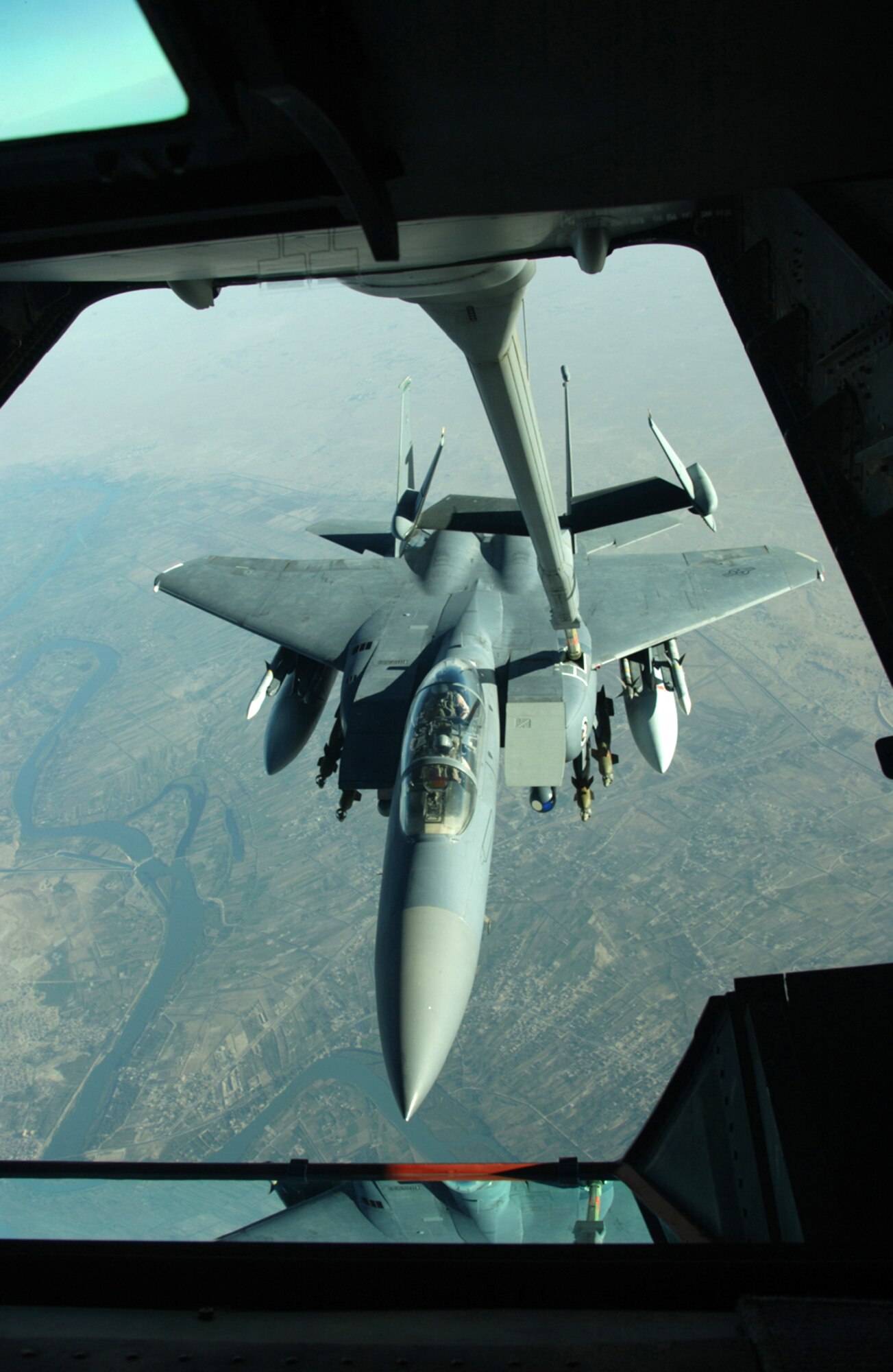 OVER IRAQ -- An F-15E Strike Eagle receives fuel from a 908th Expeditionary Aerial Refueling Squadron KC-10 Extender during a mission over Iraq.  (U.S. Air Force photo by Senior Master Sgt. Mark Moss)