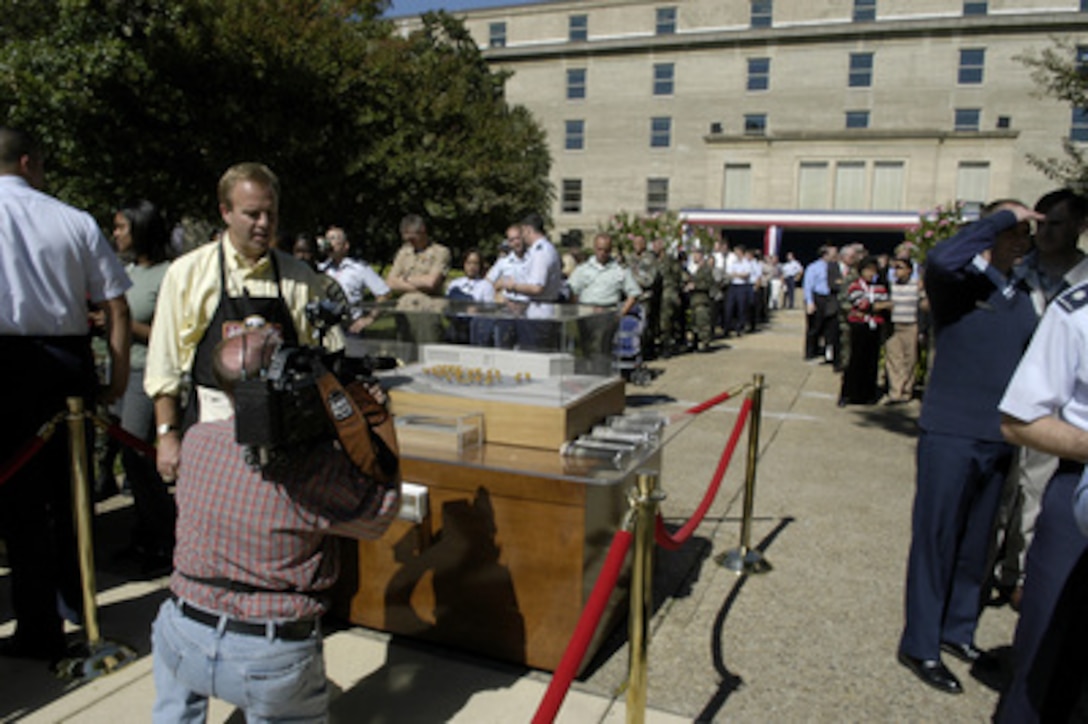 President of the Pentagon Memorial Fund James J. Laychak videotapes a segment promoting the Pentagon Brats and Music Festival to help raise money for the Pentagon Memorial on Oct 7, 2004. Pentagon personnel lined up in the center courtyard for a bratwurst lunch and chance to meet Miss America Deidre Downs, Miss Virginia Mariah Rice and the Washington Redskins' Cheerleaders. Sponsors of the event are Johnsonville Sausage, Pepsi, Frito-Lay, Master Foods, HJ Heinz, and Stroehmanns Bread. All proceeds were donated to the Memorial Fund. 