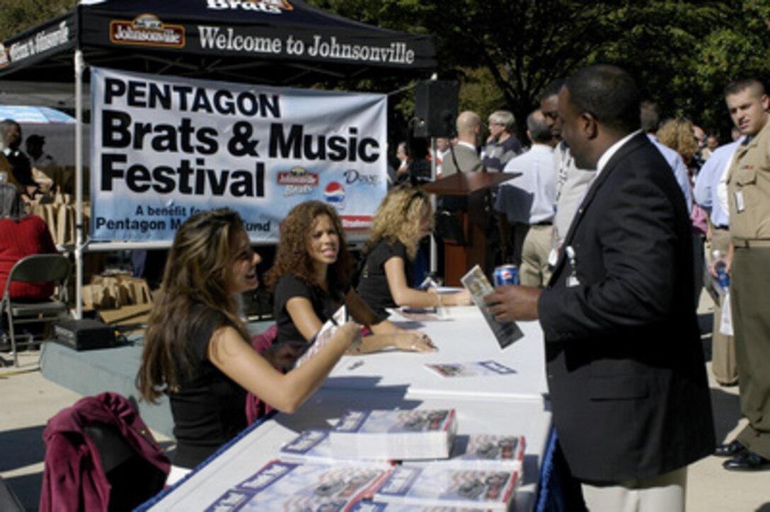 Washington Redskins' Cheerleaders autograph photos during the Pentagon Brats and Music Festival on Oct. 7, 2004. Pentagon personnel lined up in the center courtyard for a bratwurst lunch and chance to meet Miss America Deidre Downs, Miss Virginia Mariah Rice and the Washington Redskins' Cheerleaders. Sponsors of the event are Johnsonville Sausage, Pepsi, Frito-Lay, Master Foods, HJ Heinz, and Stroehmanns Bread. All proceeds were donated to the Memorial Fund. 