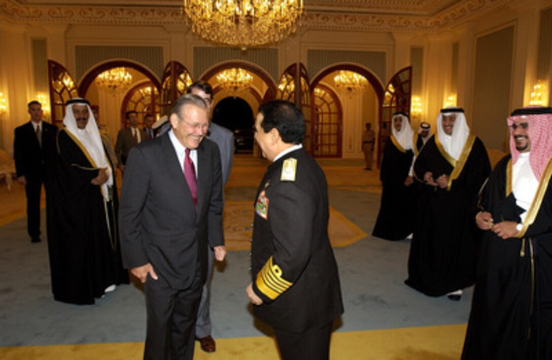 Secretary of Defense Donald H. Rumsfeld (left) is greeted by Crown Prince Salman bin Hamad al Khalifa in the Gudaibiya Palace in Manama, Bahrain, on Oct 9, 2004. Rumsfeld is in Bahrain to attend a bi-lateral meeting with the Crown Prince. 