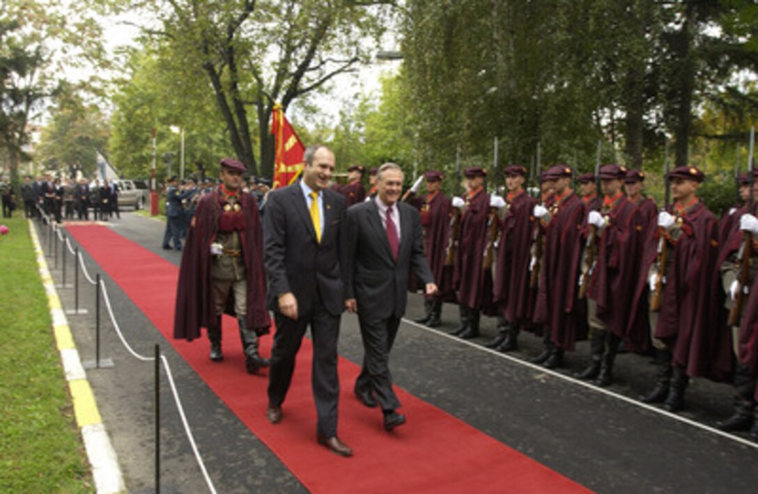 Secretary of Defense Donald H. Rumsfeld (right) is escorted by the Macedonian Minister of Defense Vlado Buckovski as he reviews the honor guard at the Ministry of Defense on Oct 11, 2004. Rumsfeld is in Macedonia to attend a bi-lateral meeting with Macedonia officials. 