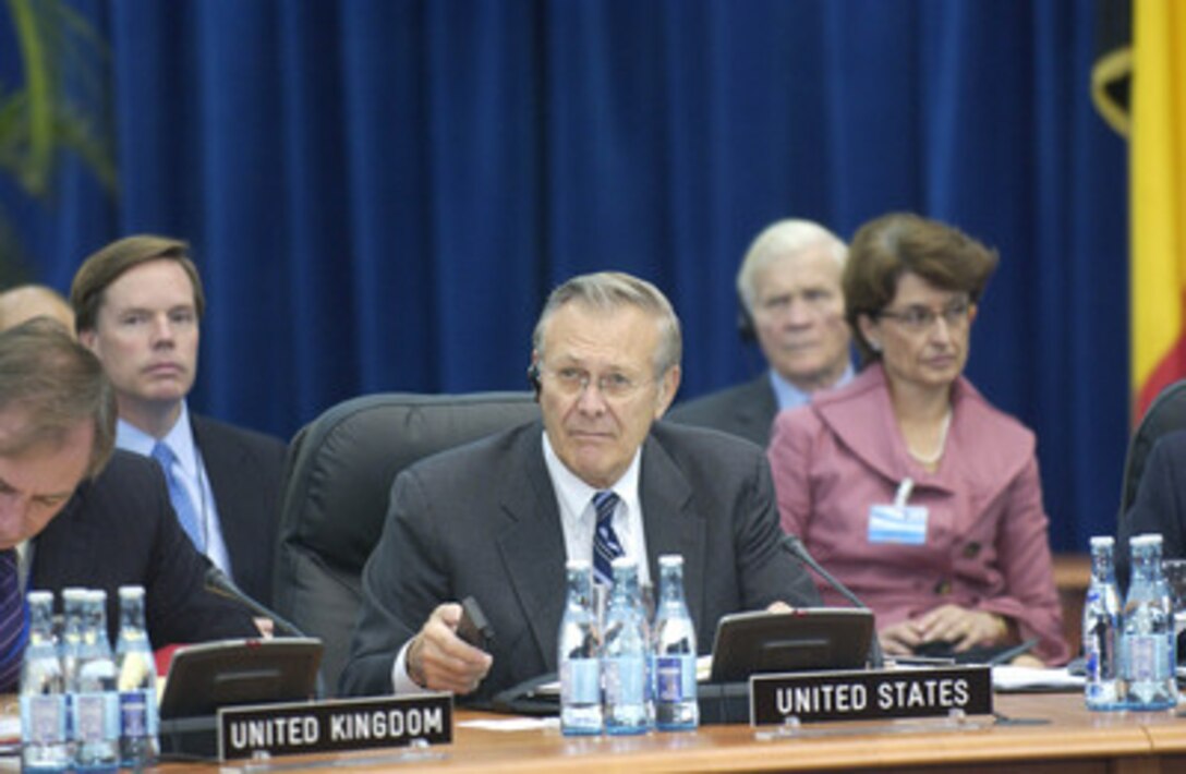 Secretary of Defense Donald H. Rumsfeld listens to comments from other NATO members during an informal meeting of NATO defense ministers in Poiana Brasov, Romania, on Oct. 13, 2004. Rumsfeld is in Romania for the informal meeting and to hold bilateral meetings with his counterparts. 