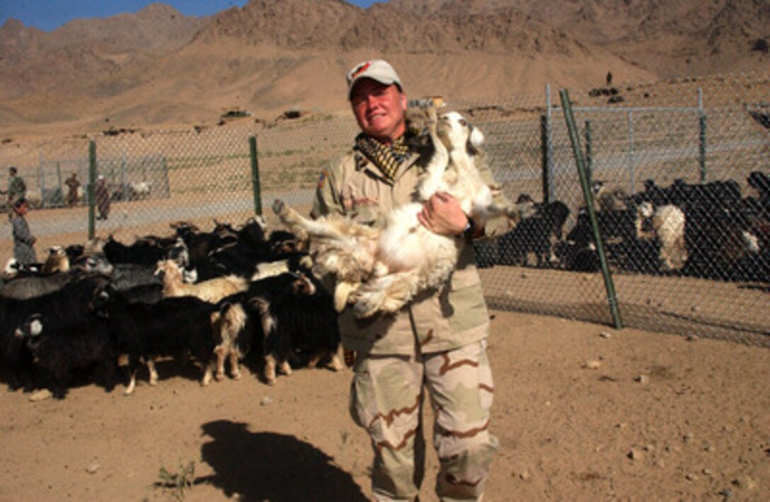 U.S. Army Spc. Amy Popke wrangles a goat to administer it medicine during a Cooperative Medical Assistance operation conducted by U.S. Army medical and veterinary personnel in Deh Afghana, Afghanistan, on Sept. 27, 2004. The medical and veterinary personnel are soldiers assigned to Task Force Victory while deployed to Afghanistan in support of Operation Enduring Freedom. Popke is a medic assigned to the Surgeon Cell of Task Force Victory. 