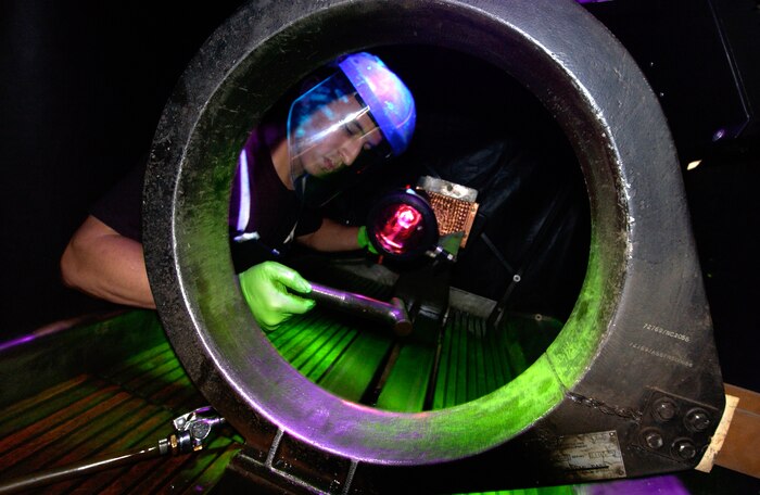 CHARLESTON AIR FORCE BASE, S.C. -- Airman 1st Class Kenny Payamps uses fluorescent magnetic particle testing to inspect a water separator bolt from a C-17 Globemaster here.  Airman Payamps is a nondestructive inspection testing journeyman assigned to the 437th Maintenance Squadron.  (U.S. Air Force photo by Tech. Sgt John M. Foster)