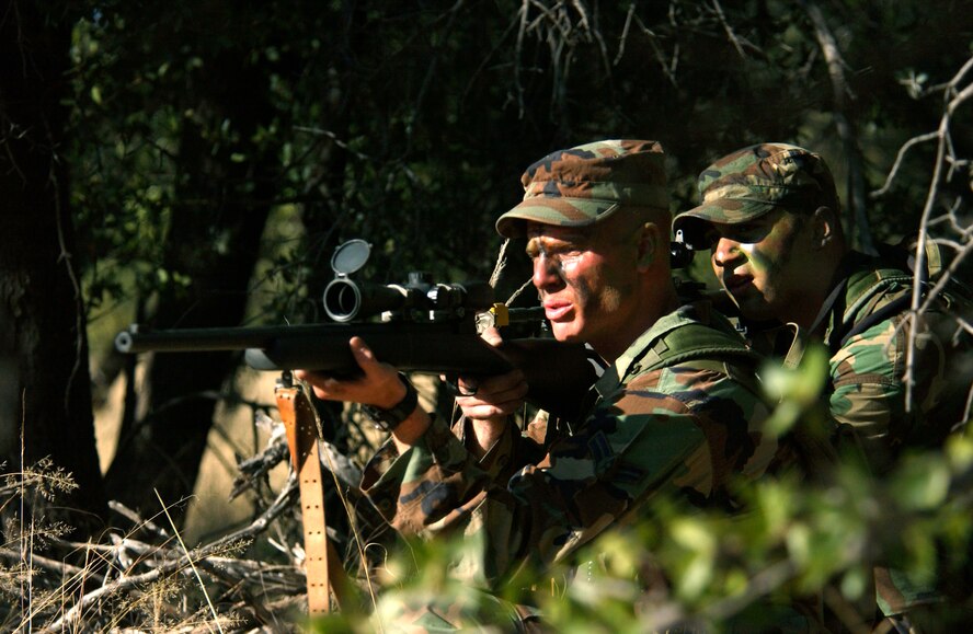 FORT HUACHUCA, Ariz. -- Senior Airman Adam Dermish and Airman 1st Class Jason Johnston acquire enemy targets during a tactics training exercise Oct. 13.  Members of the U.S. Air Forces in Europe Defender Challenge team are spending three weeks here in preparation for the 2004 Defender Challenge competition. Defender Challenge held at Lackland Air Force Base, Texas, is a security forces competition pitting competitors from major commands against one another over a series of events including marksmanship, tactics and physical fitness.  Both Airmen are assigned to the 48th Security Forces Squadron, Royal Air Force Lakenheath, England.  (U.S. Air Force photo by Tech. Sgt. Justin D. Pyle) 