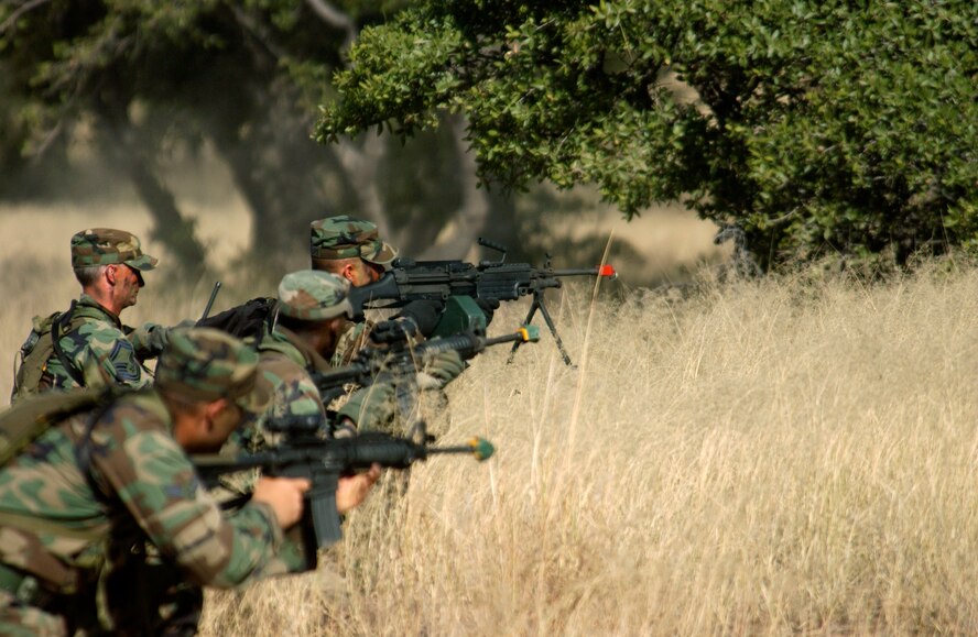 FORT HUACHUCA, Ariz. - Members of the U.S. Air Forces in Europe Defender Challenge team set up a base of fire after contact with enemy forces during a tactics training exercise Oct. 13.  The team is spending three weeks here in preparation for the 2004 Defender Challenge competition. Defender Challenge held at Lackland Air Force Base, Texas, is a security forces competition pitting competitors from major commands against one another over a series of events including marksmanship, tactics and physical fitness.  (U.S. Air Force photo by Tech. Sgt. Justin D. Pyle) 