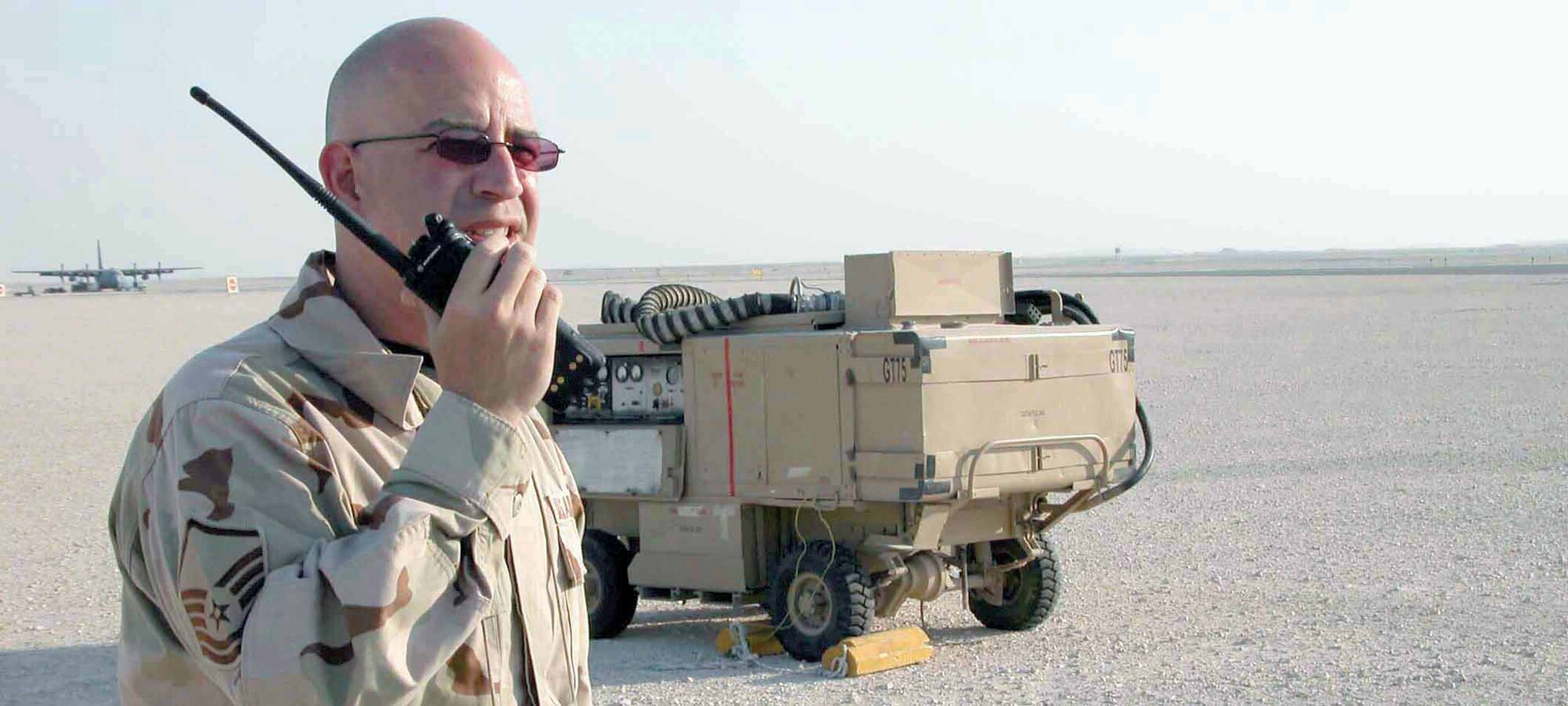 SOUTHWEST ASIA -- Master Sgt. Carlos Marrero calls the tower to close a taxiway so maintenance crews can remove aerospace ground equipment.  Sergeant Marrero is the airfield manager at a forward-deployed location.  His job requires him to inspect the airfield daily.  He is deployed from MacDill Air Force Base, Fla.  (Courtesy photo)