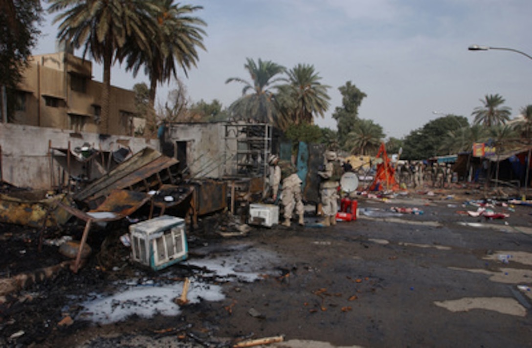 U.S. soldiers examine the debris remaining after two explosions ripped through the International Zone market place and Green Zone Café in Baghdad, Iraq, on Oct. 14, 2004. The explosions left Americans and local civilians dead or injured. 