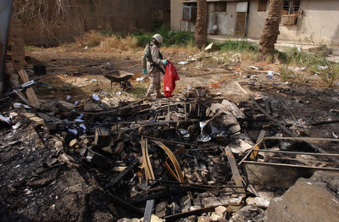 A member of the 1st Cavalry Division searches for human remains after two explosions ripped through the International Zone market place and Green Zone Café in Baghdad, Iraq, on Oct. 14, 2004. The explosions left Americans and local civilians dead or injured. 