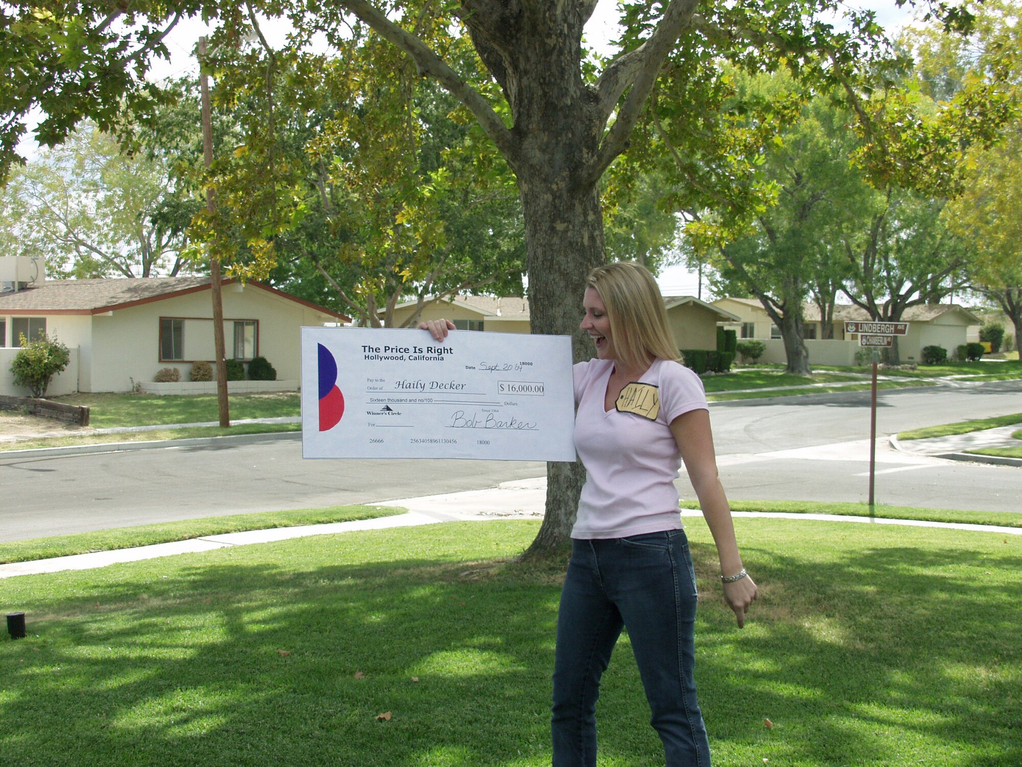 EDWARDS AIR FORCE BASE, Calif. -- Haily Decker holds a mock $16,000 check that was presented to her after winning a prize on the &quot;Price is Right&quot; during an information, tickets and travel trip.  Her husband, Capt. Shane Decker, is assigned to the Air Force Operational Test and Evaluation Center's Detachment 5 here.  (U.S. Air Force photo by Melissa Ackman)
