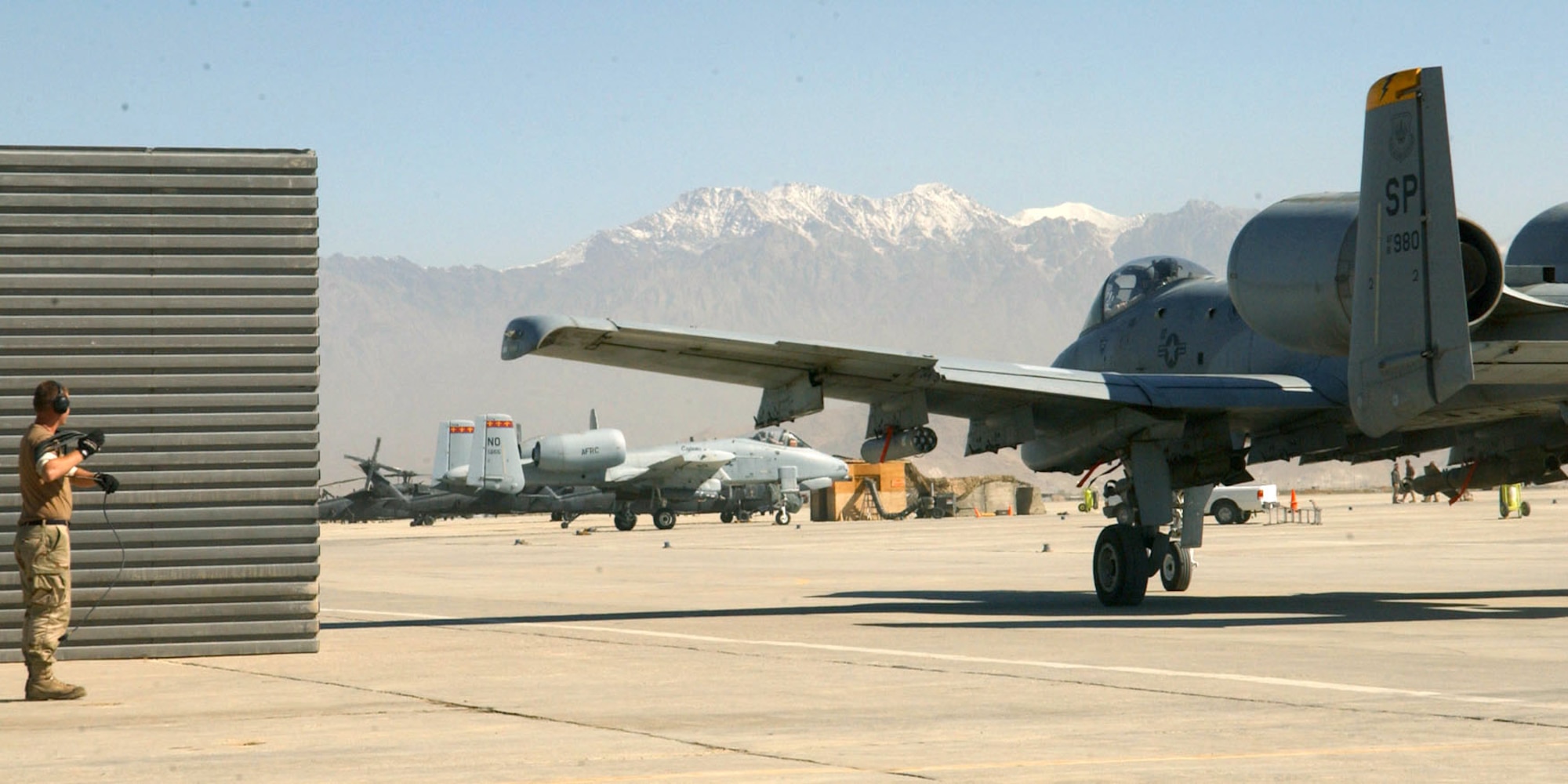 BAGRAM AIR BASE, Afghanistan -- Airman 1st Class Jay Marshall watches as 81st Expeditionary Fighter Squadron A-10s taxi down the runway for takeoff Oct. 13.  The fighter squadron here is comprised of A-10 Thunderbolts, operations support technicians and maintainers from Spangdahlem Air Base, Germany, and Naval Air Station Joint Reserve Base New Orleans.  Airman Marshall is a crew chief with the 81st Expeditionary Aircraft Maintenance Squadron here and is deployed from Spangdahlem.  (U.S. Air Force photo by Staff Sgt. Jennifer Lindsey) 