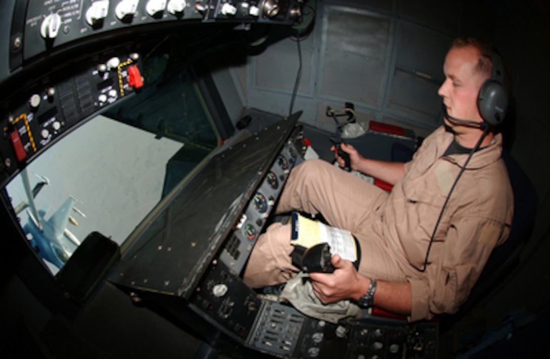 Air Force Staff Sgt. David Megill controls the boom during an in-flight refueling of an F-16 Falcon from a KC-10 Extender in the sky over Iraq on Oct. 11, 2004. Megill is a boom operator with the 908th Expeditionary Air Refueling Squadron. 