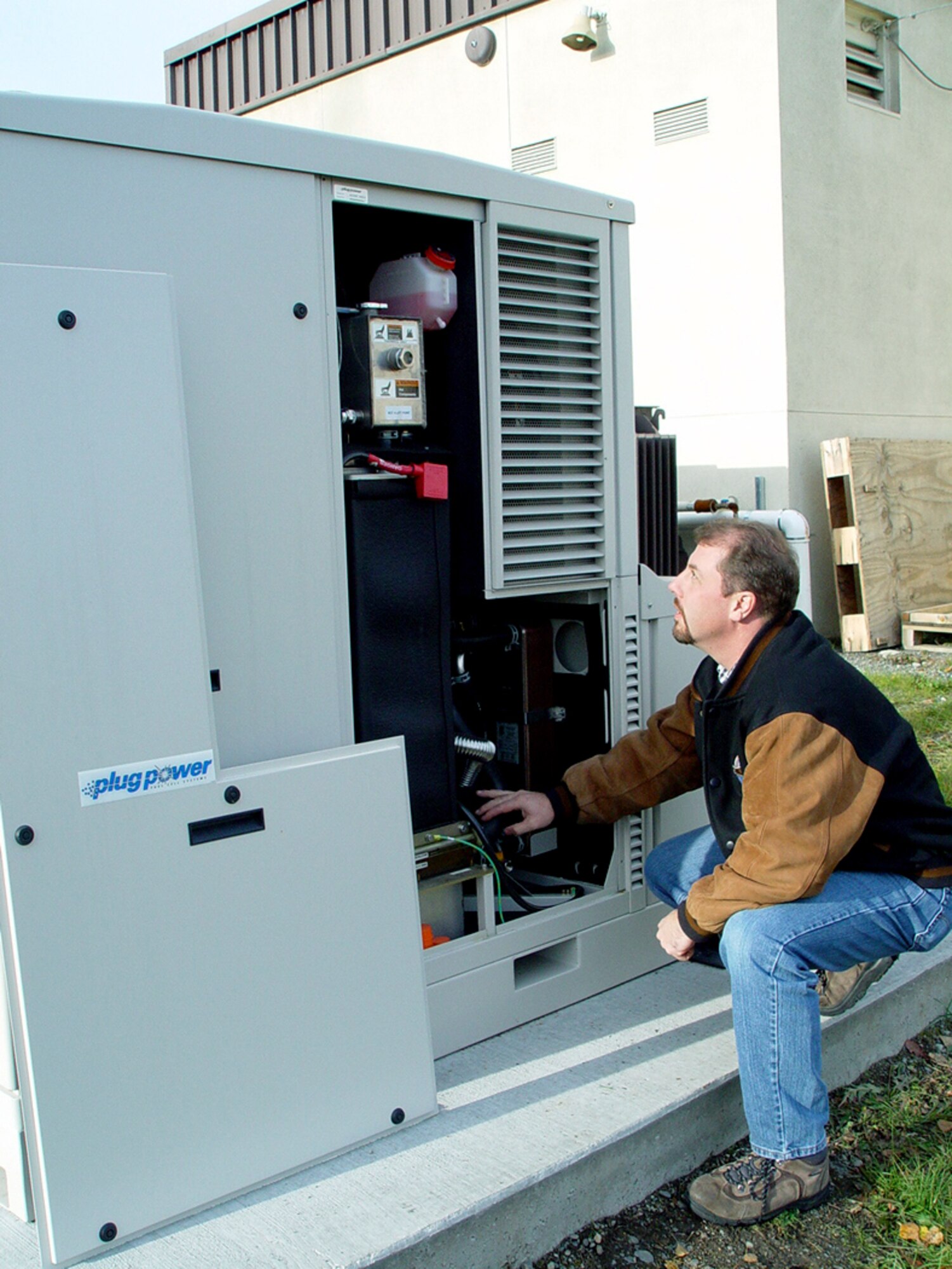 ELMENDORF AIR FORCE BASE, Alaska -- Air Force contractor, Jeff Server, a mechanical engineer, checks a fuel cell unit at a fire station here Oct. 18.  The fuel cell is an environmentally-friendly power source being tested at Elmendorf.  (U.S. Air Force photo by Jon K. Scudder)