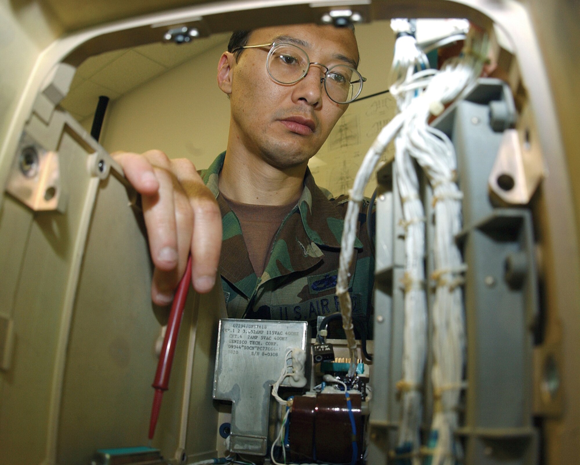 SEYMOUR JOHNSON AIR FORCE BASE, N.C. -- Tech. Sgt. Mark Kobayashi, a circuit card repair technician, works on a multi-purpose display unit.  His suggestion to repair these units and heads-up display units locally saved the Air Force more than $2.7 million, for which he was awarded $18,000.  Sergeant Kobayashi is assigned to the 4th Maintenance Group here.  (U.S. Air Force photo by Airman 1st Class J.G. Buzanowski)