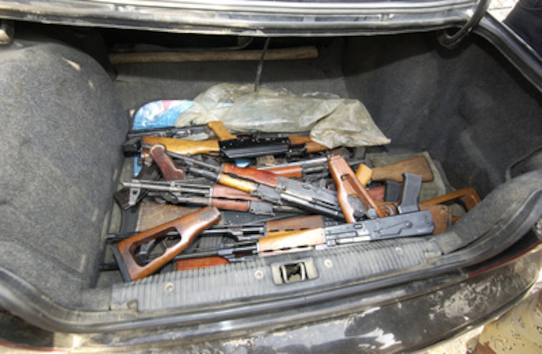 The trunk of a car contains various weapons when it arrives at the Al-Jezaaer Police Station during the initial day of Sadr Bureau's weapons buy-back program in Sadr City, Iraq, on Oct. 11, 2004. Insurgents were encouraged to bring their weapons to the local police precincts throughout Sadr city in exchange for government coupons and money. 