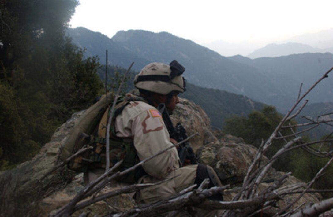 A U.S. Army soldier provides security as a gun team moves down a mountain after making contact with the enemy near Ganjgal, Afghanistan, on Oct. 16, 2004. The soldiers are assigned to the 1st Battalion, 505th Parachute Infantry Regiment. 