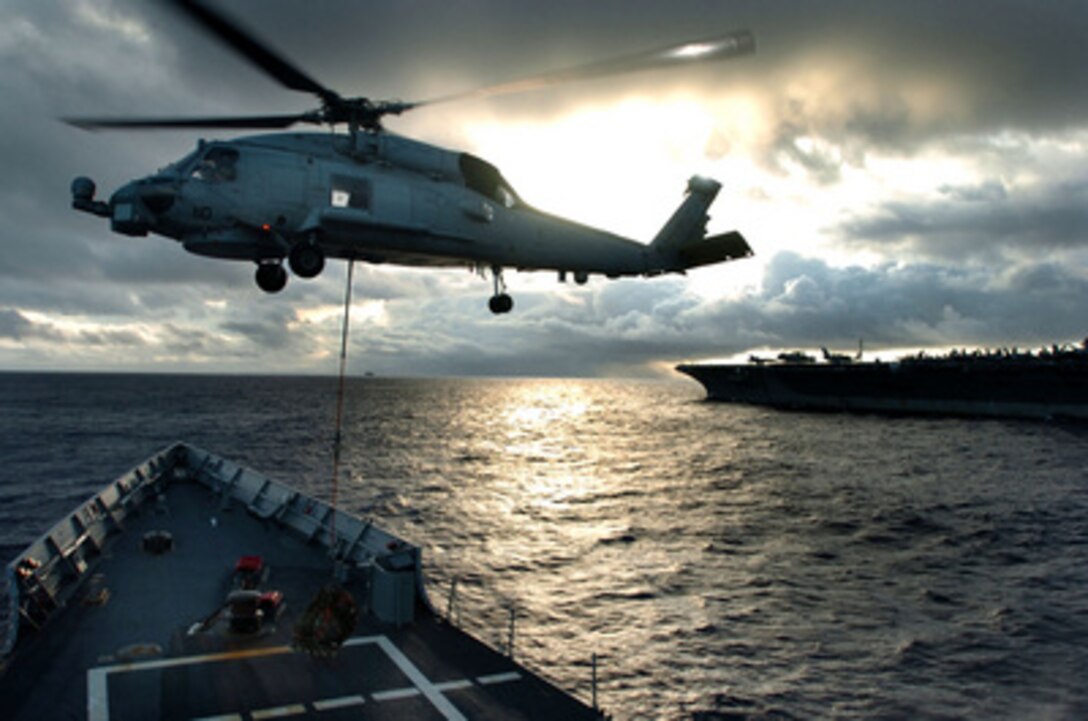 A SH-60 Seahawk helicopter picks up cargo from the flight deck of the USS Ford (FFG 54) during a vertical replenishment operation with the aircraft carrier USS John C. Stennis (CVN 74) on Oct. 18, 2004. The Ford and its attached Helicopter Anti-submarine Squadron 49 are on a deployment with the Stennis strike group. 