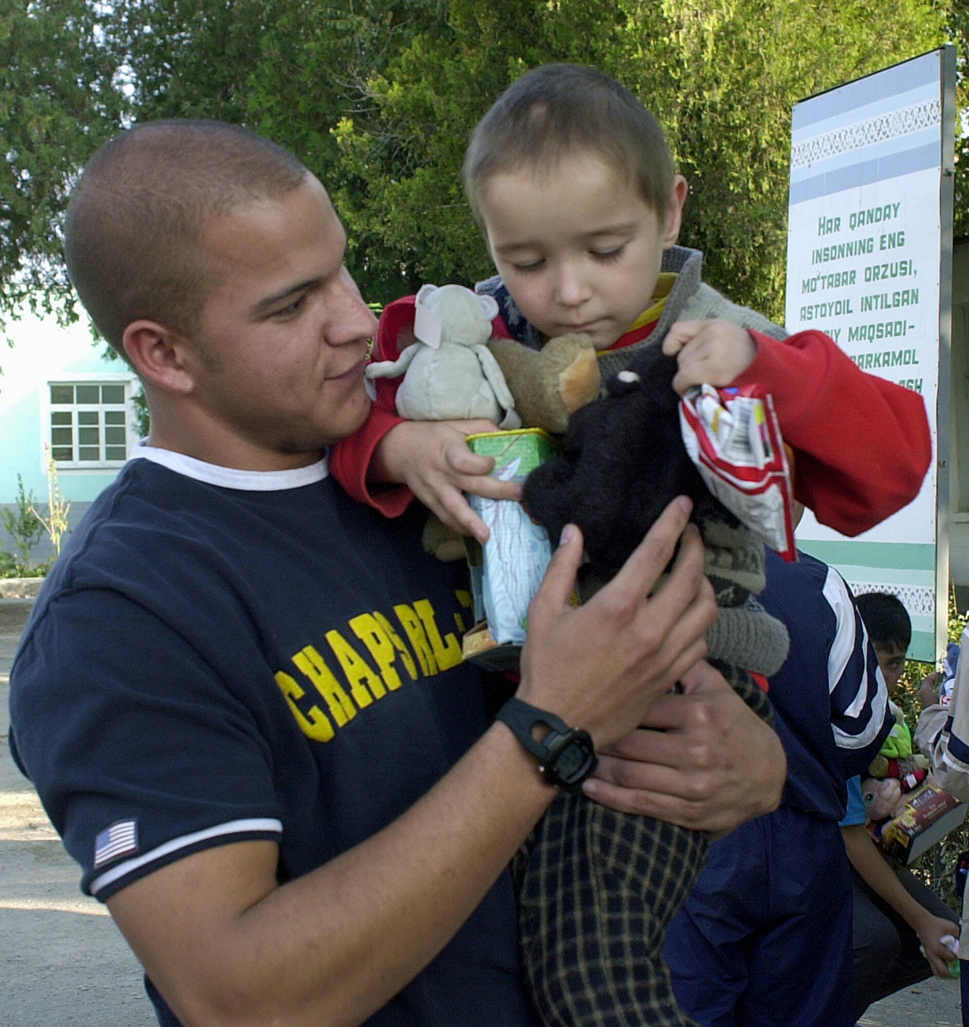 KARSHI, Uzbekistan -- Airman 1st Class Nick Melahn plays with a 4-year-old orphan at a children's home here.  The facility is a home for orphans and poor children whose families are unable to take care of them.  He is assigned to the 416th Air Expeditionary Group at nearby Karshi-Khanabad. (U.S. Air Force photo by Senior Airman Matthew Rosine)
