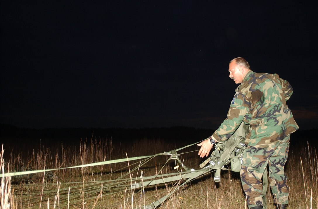 MARINE CORPS BASE CAMP LEJEUNE, N.C. - Royal Dutch Marine Master Sgt. Peter J. Laurier, a native of Rotterdam, Netherlands, currently assigned to the 6th Marine Regiment as a martial arts trainer, gathers his parachute after conducting a successful parachute drop over drop zone Pheasant recently.  Laurier and other Marines assigned to various other units including 2d Air Delivery Platoon, 2d Transportation Support Battalion, concluded a successful week of airborne and air delivery operations with a night airborne jump.