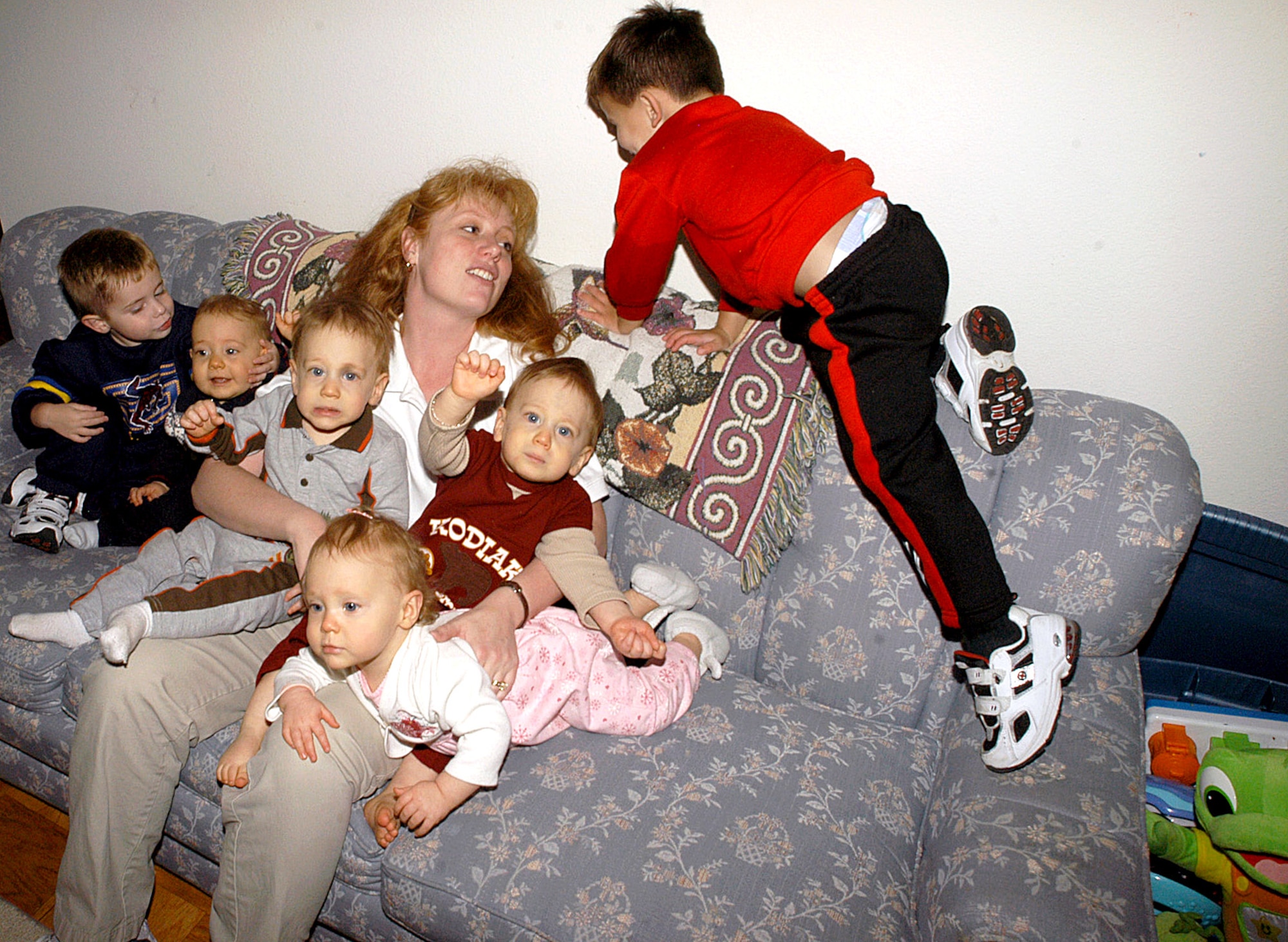 EDWARDS AIR FORCE BASE, Calif. -- Jackie Kearl tries to get her children together for a group photo here.  They are (from left) 3-year-old Hunter, 1-year-olds Bryan, Jayson, Cassie and Nathan, and 3-year-old Tanner Kearl.  Mrs. Kearl is married to Capt. Jay Kearl of the U.S. Air Force Test Pilot School.  (U.S. Air Force photo by Senior Airman Jet Fabara)
