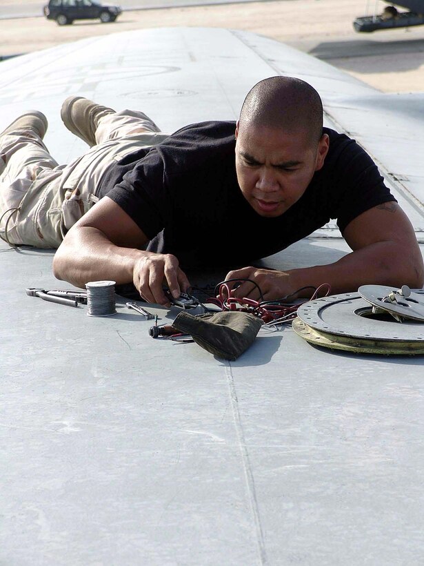 SOUTHWEST ASIA -- Airman 1st Class Rommel Novico works on the wiring for a C-130 Hercules on Oct. 18 as the aircraft is prepared for a mission into Iraq.  He is assigned to the 746th Expeditionary Maintenance Squadron at a forward-deployed location and is from Ramstein Air Base, Germany.  (U.S. Air Force photo by Senior Airman Nicole Spence)