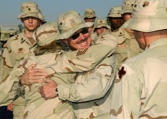 KANDAHAR AIRFIELD, Afghanistan -- Tech. Sgt. Rebecca Jo Allen hugs her newly promoted brother, Chief Warrant Officer Tim Gaby.  She is a passenger terminal nightshift manager assigned to the 455th Expeditionary Logistics Readiness Squadron at Bagram Air Base, Afghanistan.  Chief Gaby is an ammunition supply point accountable officer assigned to the 221st Ordnance Co.  (U.S. Air Force photo by Staff Sgt. Jennifer Lindsey)