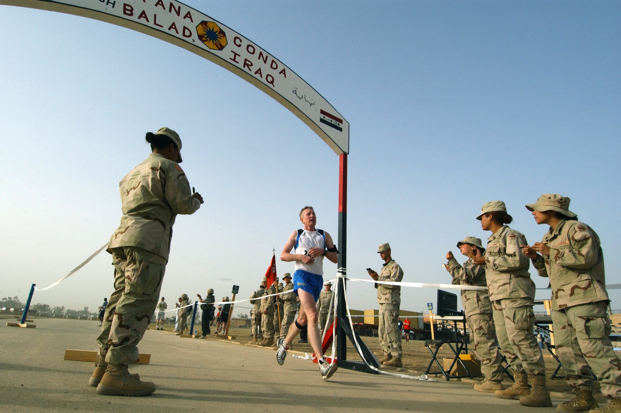 BALAD AIR BASE, Iraq -- Master Sgt. Donald Beaulieu crosses the finish line Oct. 24 at the Logistics Support Area Anaconda 10-Miler.  He came in third overall and claimed first place in his age group.  Sergeant Beaulieu is assigned to the 332nd Air Expeditionary Wing chapel and is deployed from Tinker Air Force Base, Okla.  (U.S. Air Force photo by Tech. Sgt. Robert Jensen)