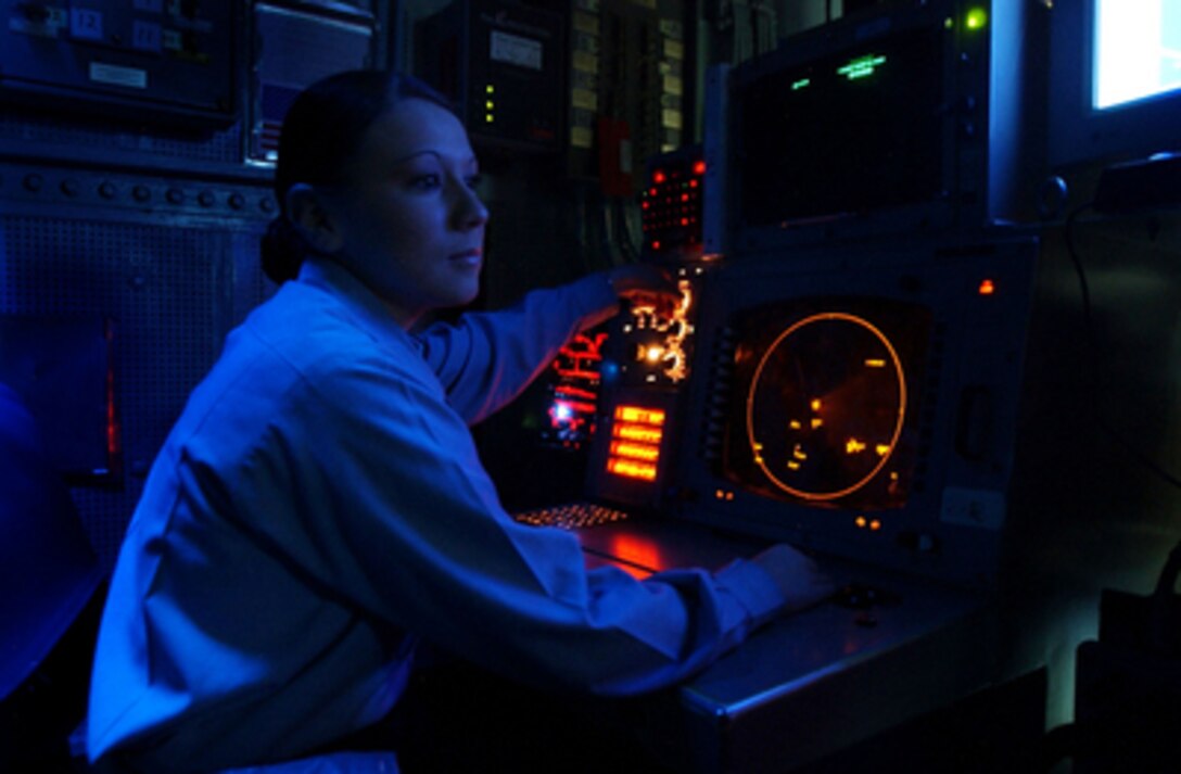 Petty Officer 3rd class Amy Ramirez monitors a tactical situation display screen in the Combat Directive Center aboard the aircraft carrier USS John C. Stennis (CVN 74) on Oct. 16, 2004. Stennis and its embarked Carrier Air Wing 14 are on deployment in the western Pacific Ocean. Ramirez is a Navy operations specialist. 