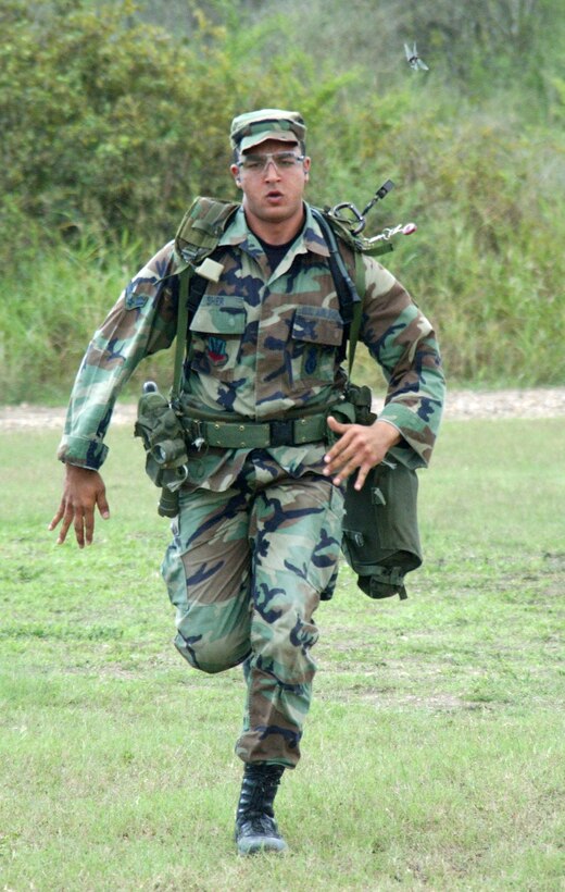 LACKLAND AIR FORCE BASE, Texas (AFPN) -- Airman 1st Class Sarosh Sher sprints to the aid of a simulated downed Airman during the handgun and shotgun event at Defender Challenge 2004.  Airman Sher, from the 99th Security Support Squadron at Nellis Air Force Base, Nev., is on the Air Combat Command team.  The annual Defender Challenge here pits security forces teams from Air Force major commands, the Royal Air Force Regiment and the Department of Energy against each other in events that test marksmanship, tactics, physical fitness and teamwork.  This year's competition runs Oct. 23 to 28.  (U.S. Air Force photo by Gary Emery)