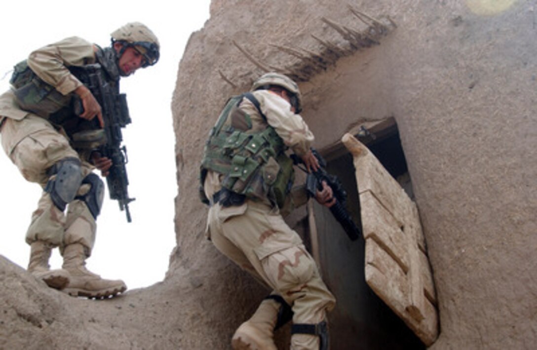 U.S. Army soldiers enter a building believed to be storing illegal weapons during a combat raid in Zurmat, Afghanistan, on Oct. 16, 2004. The soldiers are assigned to the 82nd Airborne Division, Bravo Company, 1st Battalion, 505th Parachute Infantry Regiment. 