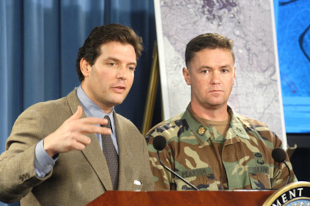 Principal Deputy Assistant Secretary of Defense for Public Affairs Lawrence Di Rita and Army Maj. Austin Pearson conduct a Pentagon press briefing on Oct. 29, 2004, to discuss what is known concerning the reports of large quantities of missing Iraqi munitions from the Al Qa Qaa storage facility south of Baghdad, Iraq. Pearson detailed how the ordnance unit he commanded during the Iraq war was tasked to remove "easily accessible munitions" from the Al Qa Qaa facility. 