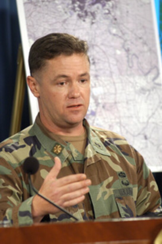 Army Maj. Austin Pearson relates his recollections of the Al Qa Qaa munitions storage compound to reporters at the Pentagon during a press conference with Principal Deputy Assistant Secretary of Defense for Public Affairs Lawrence Di Rita on Oct. 29, 2004. Pearson detailed how the ordnance unit he commanded during the Iraq war was tasked to remove "easily accessible munitions" from the Al Qa Qaa facility. 