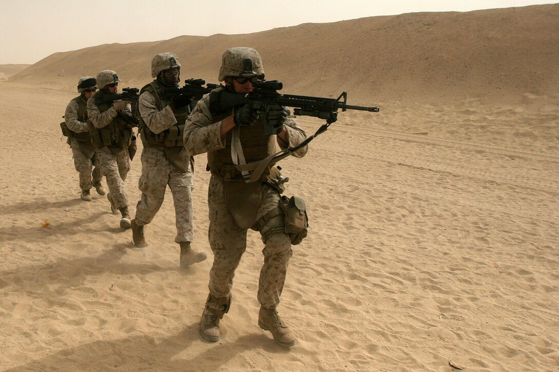 Light Armored Vehicle Scouts with Weapons Company Battalion Landing Team 2/5, 15th Marine Expeditionary Unit, advance toward an objective during a live fire Military Operations in Urban Terrain exercise in Northern Kuwait.::r::::n:: Weapons Company came ashore to Kuwait in late June to conduct sustainment training, ensuring vital war fighting skills are not lost.::r::::n::    Kuwait provides open space for the company to practice combat driving skills and ranges to conduct live fire exercises.::r::::n::    The Camp Pendleton, Calif. based 15th MEU is comprised of approximately 2,200 Marines and Sailors and is a forward deployed force of readiness capable of conducting numerous operations, such as Non-Combatant Evacuation Operations, Humanitarian Assistance Operations and a wide range of amphibious missions. The 15th MEU is currently conducting sustainment training in Kuwait. (Official USMC photo by Cpl. Stephen Holt)(Released)::r::::n::