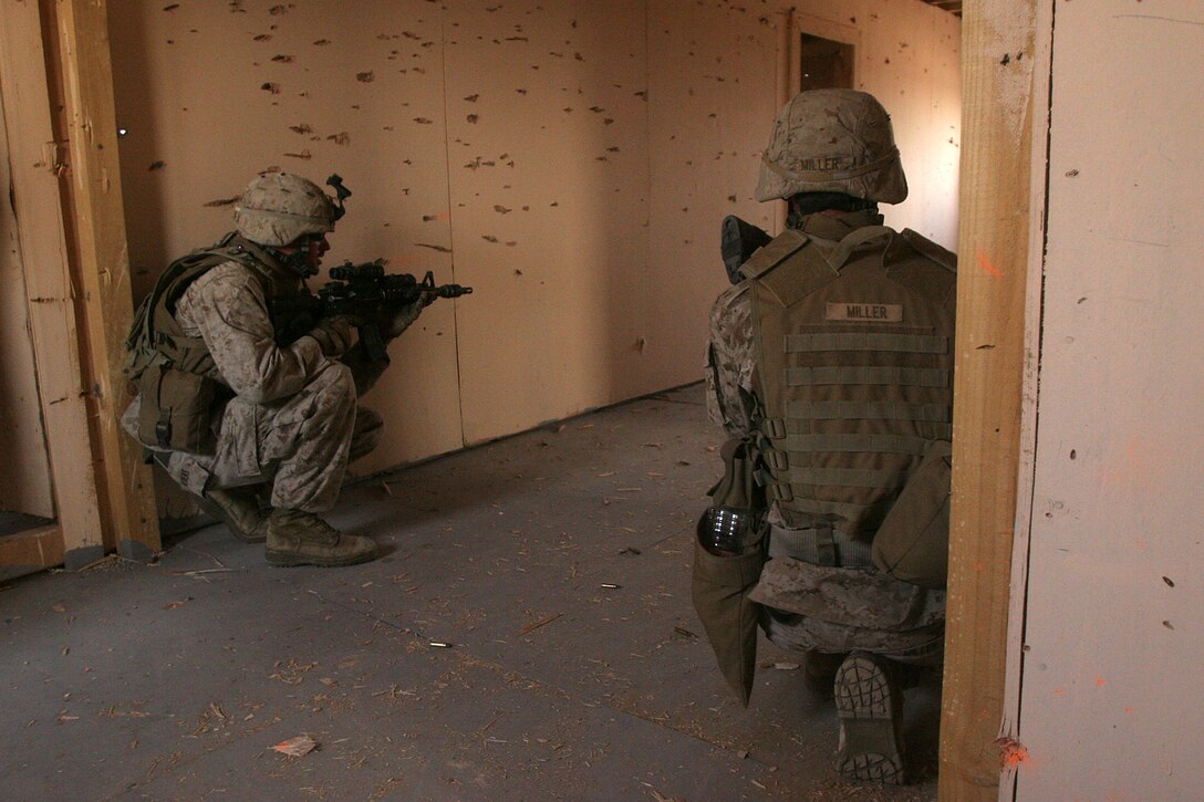 Sgt. Alexander Hebert and Cpl. Matthew Miller, Light Armored Vehicle Scouts with Weapons Company Battalion Landing Team 2/5, 15th Marine Expeditionary Unit, secure a hallway in a shoot house during a live fire Military Operations in Urban Terrain exercise in Northern Kuwait.::r::::n:: Weapons Company came ashore to Kuwait in late June to conduct sustainment training, ensuring vital war fighting skills are not lost.::r::::n::    Kuwait provides open space for the company to practice combat driving skills and ranges to conduct live fire exercises.::r::::n::    The Camp Pendleton, Calif. based 15th MEU is comprised of approximately 2,200 Marines and Sailors and is a forward deployed force of readiness capable of conducting numerous operations, such as Non-Combatant Evacuation Operations, Humanitarian Assistance Operations and a wide range of amphibious missions. The 15th MEU is currently conducting sustainment training in Kuwait. (Official USMC photo by Cpl. Stephen Holt)(Released)::r::::n::