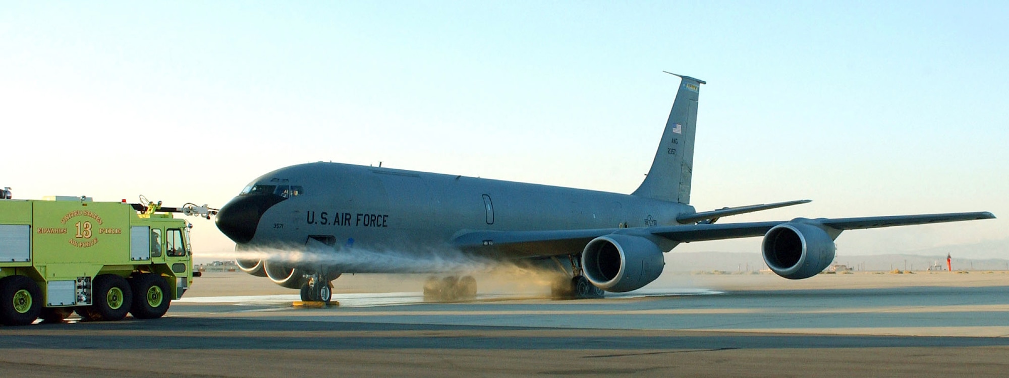 EDWARDS AIR FORCE BASE, Calif. -- Firefighters from the Air Force Flight Test Center Fire Department here spray down KC-135 Stratotanker tires after a carbon brake test.  Testing determined that carbon brakes performed more efficiently and gave the aircraft increased operational capability over steel brakes that currently equip the aircraft.  (U.S. Air Force photo by Brad White)